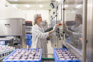 Food And Beverage Facility. Employee checking overall quality of product - Bohden Contracting Group