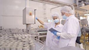 Food And Beverage Facility. Employees checking clipboard - Bohden Contracting Group